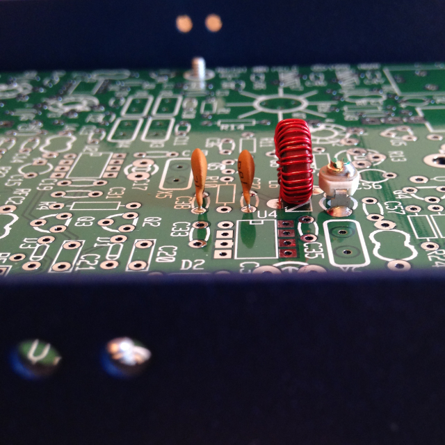 A close up view of the assembled transmit filter in the NorCal 40A transceiver, looking over the edge of the case and across the circuit board.