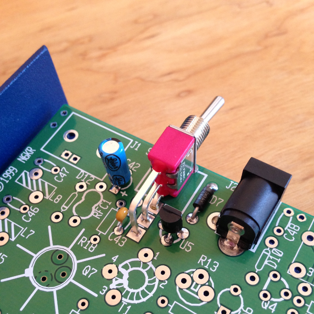 A close up view of the assembled power supply in the NorCal 40A transceiver, looking down on the on/off switch from the back.